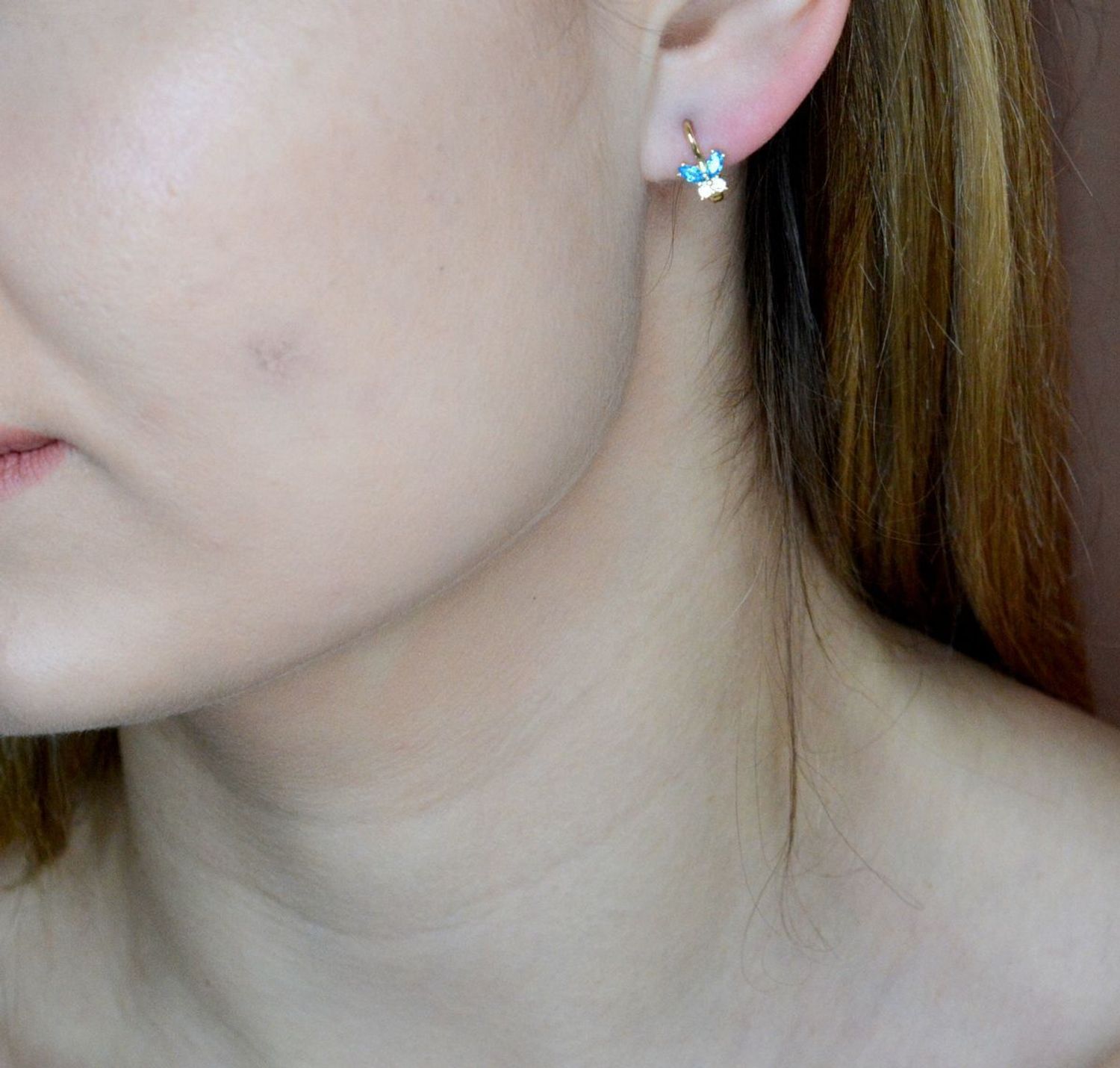 Złote kolczyki 375 motylki z niebieską cyrkonią KL 11374 375. Złote kolczyki wykonane z najwyższej jakości żółtego złota, próba 375, waga około 1,12 gram. Kolczyki w minimalistycznym stylu, wpisujące się w obecne trendy modowe. Ideal.jpg